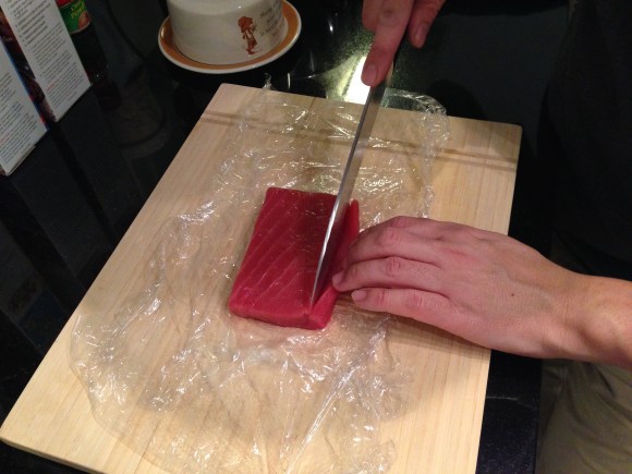 making sushi at home, slicing tuna