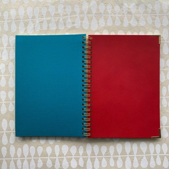 Kakimori notebook, red leather, gold accents, blue bookcloth